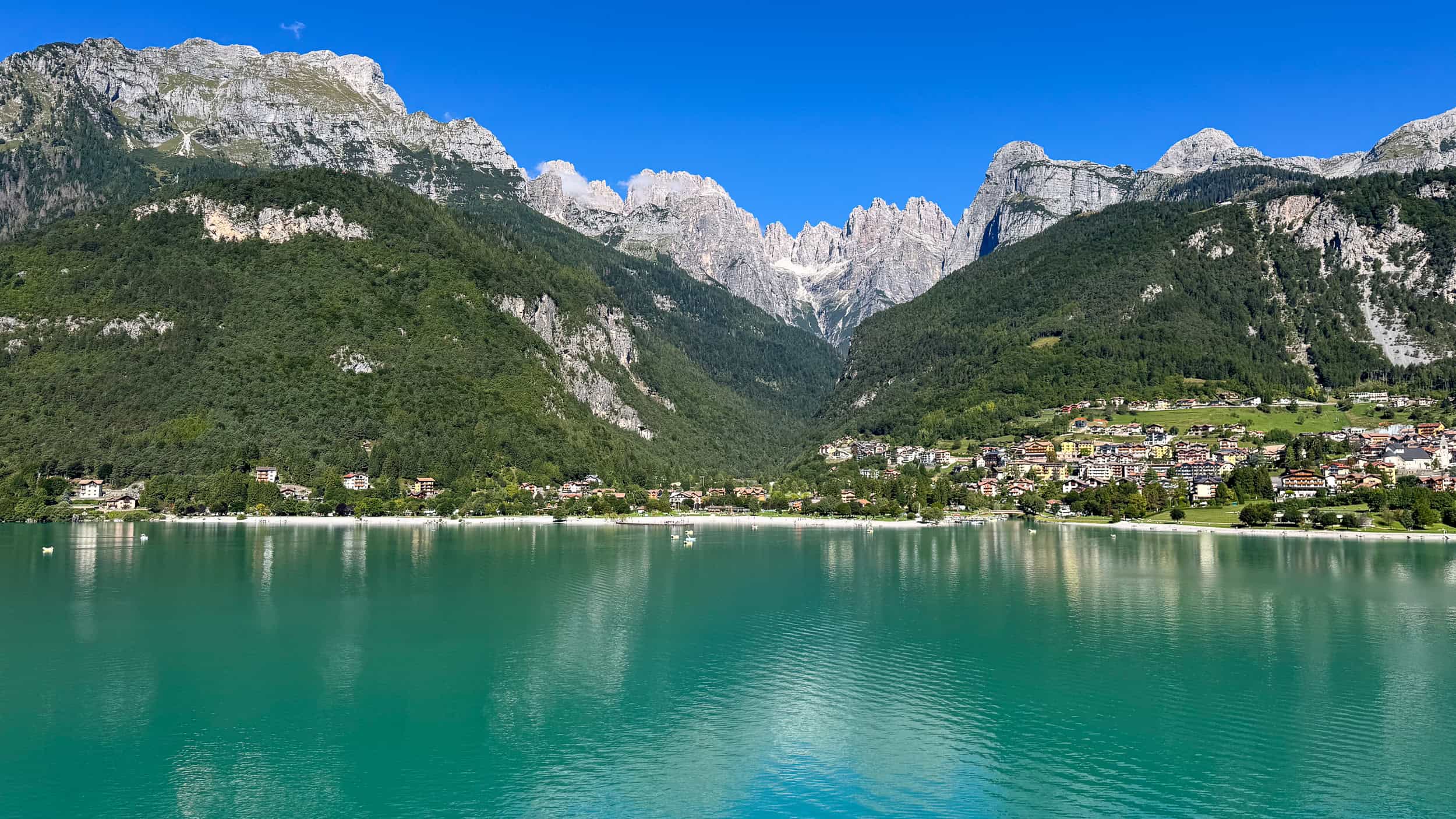 Lake Molveno, Italy with Molveno village and the Brenta Dolomite mountains.